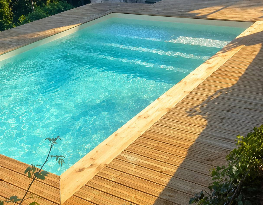 Piscine maçonnée réalisée par Bati-System avec terrasse en bois